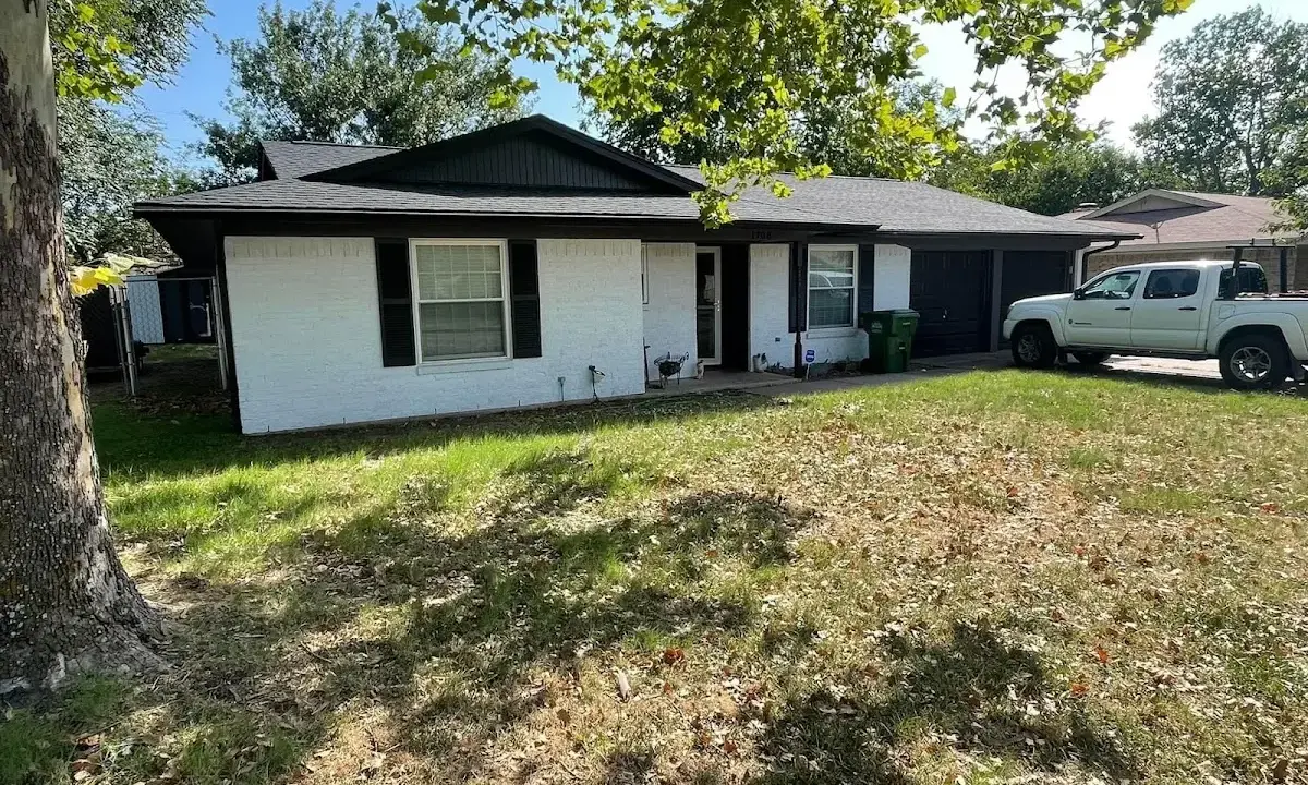 Professional roofing crew working on a residential roof in Rutherford